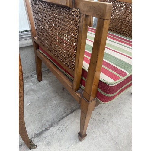 2210 - A 19TH CENTURY SATINWOOD BERGERE FIRESIDE CHAIR ON TAPERING LEGS WITH SPADE FEET