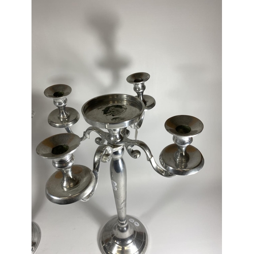 18 - A LARGE PAIR OF CHROME FOUR BRANCH CANDLESTICKS WITH CENTRAL CIRCULAR SECTION