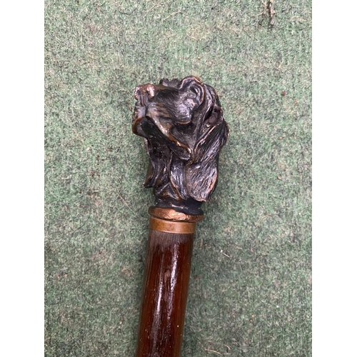 25 - A VINTAGE WOODEN WALKING STICK WITH METAL DOG HEAD FINIAL
