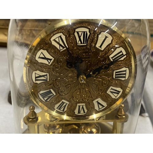 32 - A 1950'S BRASS CASED 'KUNDO' ANNIVERSARY CLOCK WITH GLASS DOME