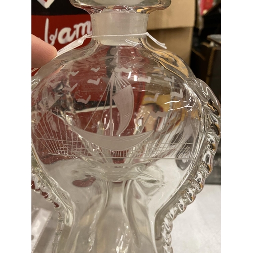 37 - A VINTAGE GLASS DECANTER WITH WAISTED FORM DESIGN WITH FOUR SHOT GLASSES