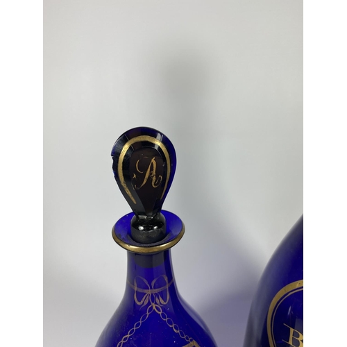 8 - TWO GEORGIAN BRISTOL BLUE GLASS DECANTERS - 'BRANDY' & 'HOLLANDS'