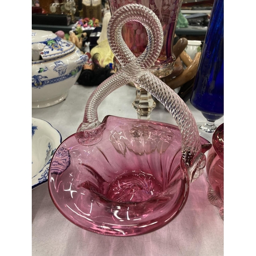 196 - THREE PIECES OF CRANBERRY GLASS TO INCLUDE A FOOTED VASE WITH EMBOSSED BIRD DECORATION, A BASKET BOW... 