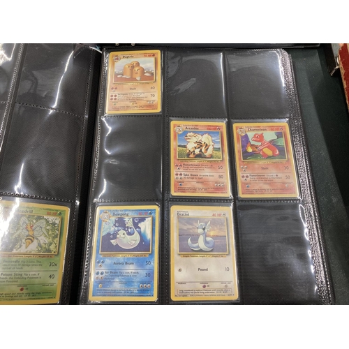 74 - A FOLDER OF POKEMON CARDS TO INCLUDE 1999 BASE SET, TOPPS SERIES 1 INCLUDING CHARIZARD AND HOLOS
