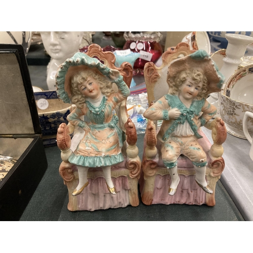 115 - A PAIR OF BISQUE CONTINENTAL SEATED FIGURES