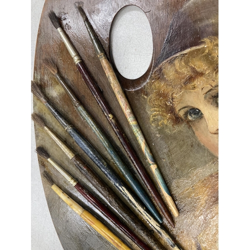 154 - A VICTORIAN PAINTED ARTISTS PALETTE WITH ATTACHED BRUSHES