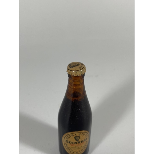 406 - A MINIATURE GUINNESS EXTRA STOUT BOTTLE