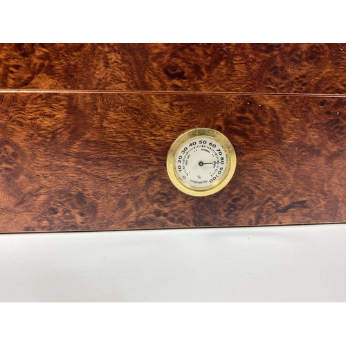 413 - A WALNUT EFFECT WOODEN CIGAR HUMIDOR WITH FRONT HYDROMETER