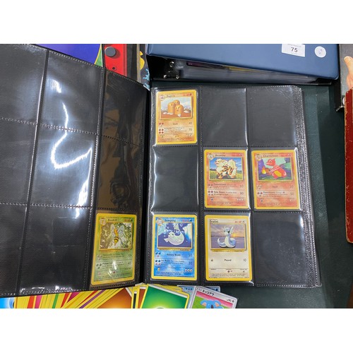 74 - A FOLDER OF POKEMON CARDS TO INCLUDE 1999 BASE SET, TOPPS SERIES 1 INCLUDING CHARIZARD AND HOLOS
