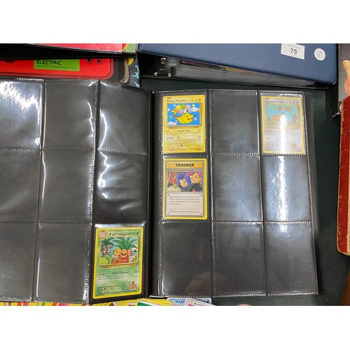 74 - A FOLDER OF POKEMON CARDS TO INCLUDE 1999 BASE SET, TOPPS SERIES 1 INCLUDING CHARIZARD AND HOLOS