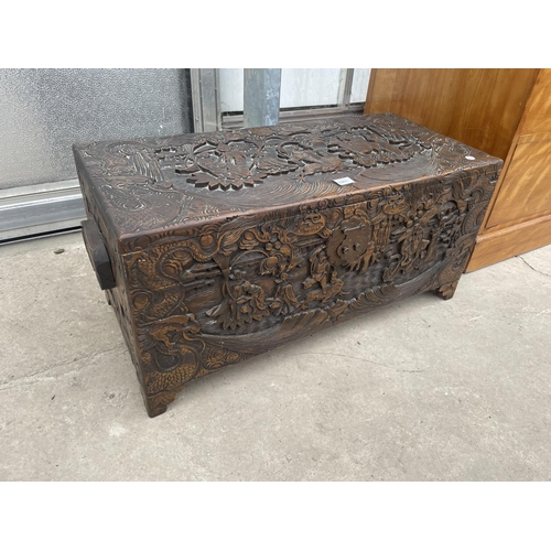 2201 - A MID 20TH CENTURY CAMPHOR WOOD CHEST PROFUSELY CARVED WITH ORIENTAL SCENES, 31.5X14.5