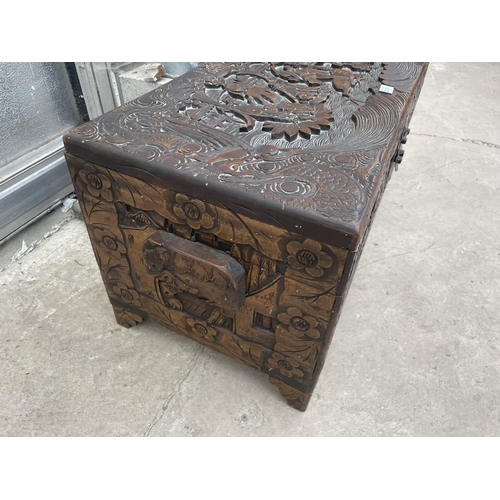 2201 - A MID 20TH CENTURY CAMPHOR WOOD CHEST PROFUSELY CARVED WITH ORIENTAL SCENES, 31.5X14.5