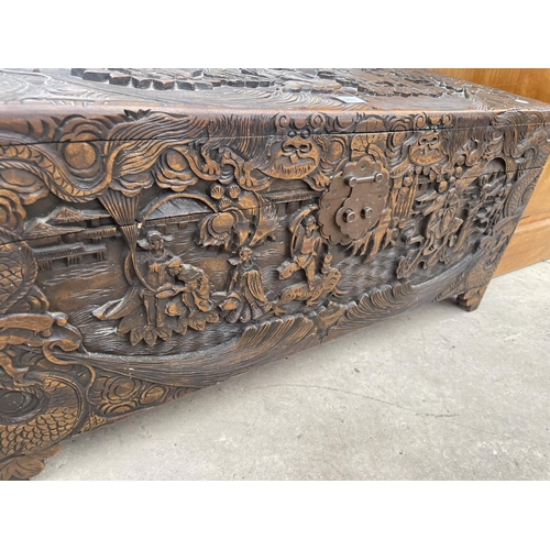 2201 - A MID 20TH CENTURY CAMPHOR WOOD CHEST PROFUSELY CARVED WITH ORIENTAL SCENES, 31.5X14.5