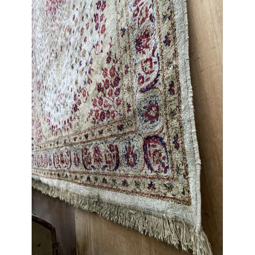 2198 - A LARGE CREAM PATTERNED FRINGED RUG BEARING THE LABEL MADE IN BELGIUM (200CM X 300CM)