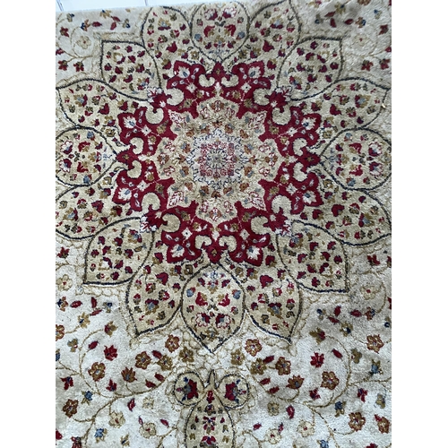 2198 - A LARGE CREAM PATTERNED FRINGED RUG BEARING THE LABEL MADE IN BELGIUM (200CM X 300CM)