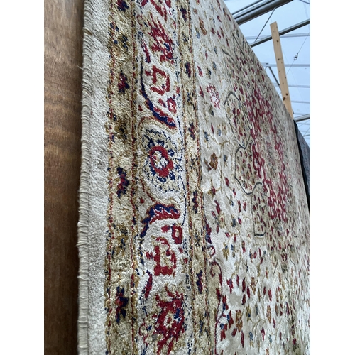 2198 - A LARGE CREAM PATTERNED FRINGED RUG BEARING THE LABEL MADE IN BELGIUM (200CM X 300CM)