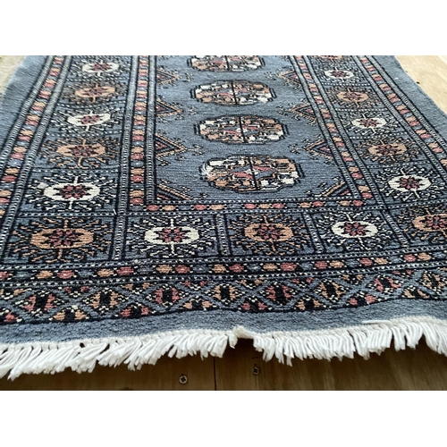 2199 - A SMALL BLUE PATTERNED FRINGED RUG