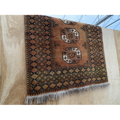 2200 - A LARGE BURNT ORANGE PATTERNED FRINGED RUG