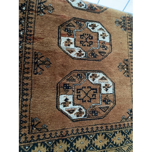 2200 - A LARGE BURNT ORANGE PATTERNED FRINGED RUG