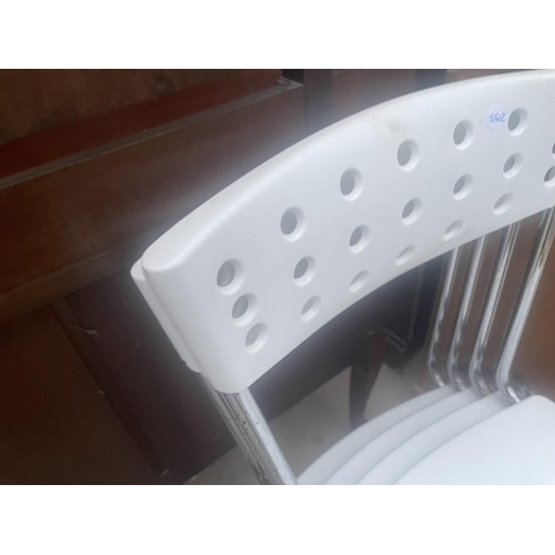 2668 - FOUR RETRO STYLE WHITE PLASTIC AND CHROME STACKING KITCHEN CHAIRS