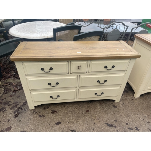 2676 - A MODERN OAK AND CREAM  CHEST OF SEVEN DRAWERS - 135 CM X 43 CM X 80 CM HIGH