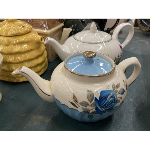 109 - A QUANTITY OF TEAPOTS TO INCLUDE BURLEIGHWARE, SADLER, POOLE, ETC PLUS MUGS