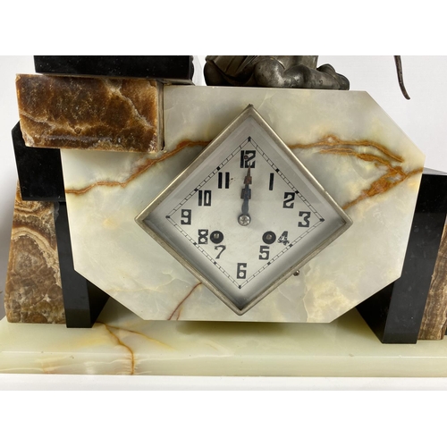 91 - AN ART DECO MANTLE CLOCK WITH GIRL WITH BIRD FINIAL DESIGN AND SIDE GARNITURES