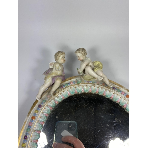 32 - A CONTINENTAL PORCELAIN MIRROR WITH CHERUB AND FLORAL DESIGN