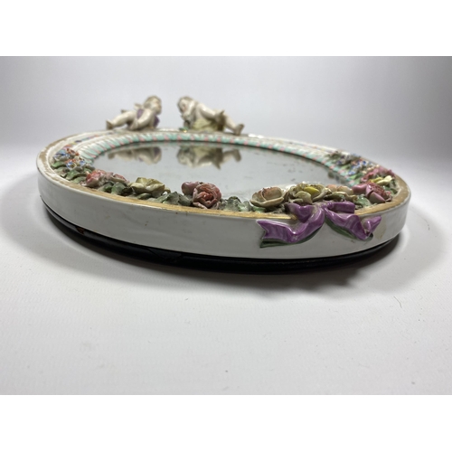 32 - A CONTINENTAL PORCELAIN MIRROR WITH CHERUB AND FLORAL DESIGN