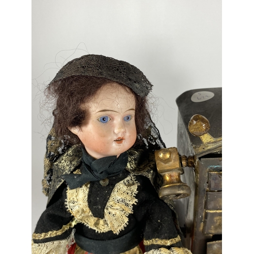 39 - AN UNUSUAL MUSICAL PORCELAIN HEADED DOLL FIGURE OF A HOT POTATO SELLER