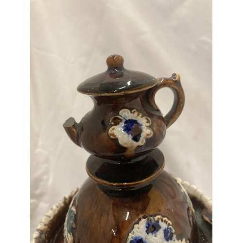 182 - A LARGE TREACLE GLAZED BARGEWARE TEAPOT - A/F HEIGHT APPROX 33CM