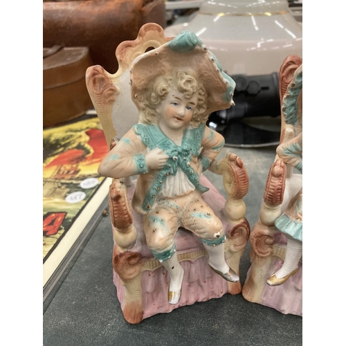 198 - A PAIR OF BISQUE CONTINENTAL SEATED FIGURES