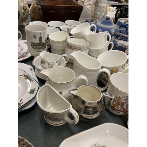 210 - A LARGE QUANTITY OF MUGS, CUPS AND PLATES TO INCLUDE A JOHNSON BROS CHRISTMAS PLATE