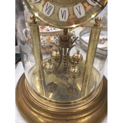 228 - A GERMAN MANTLE CLOCK IN A GLASS DOME