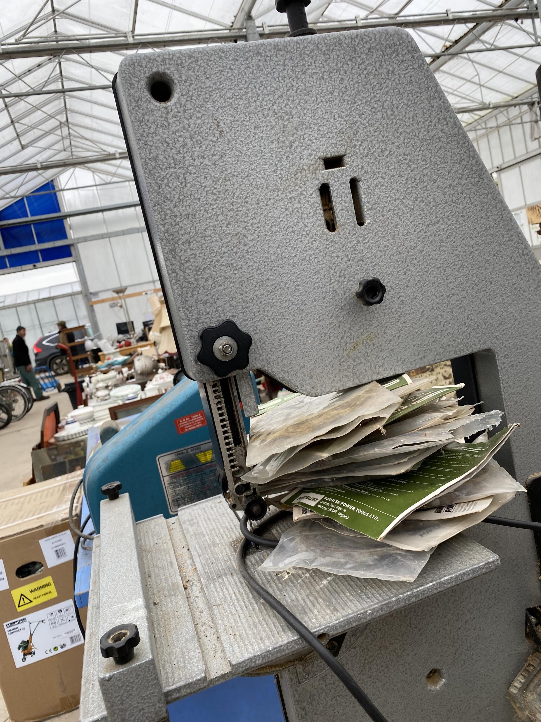 A DEWALT DW3501 ELECTRIC BAND SAW WITH STAND AND SPARE BLADES
