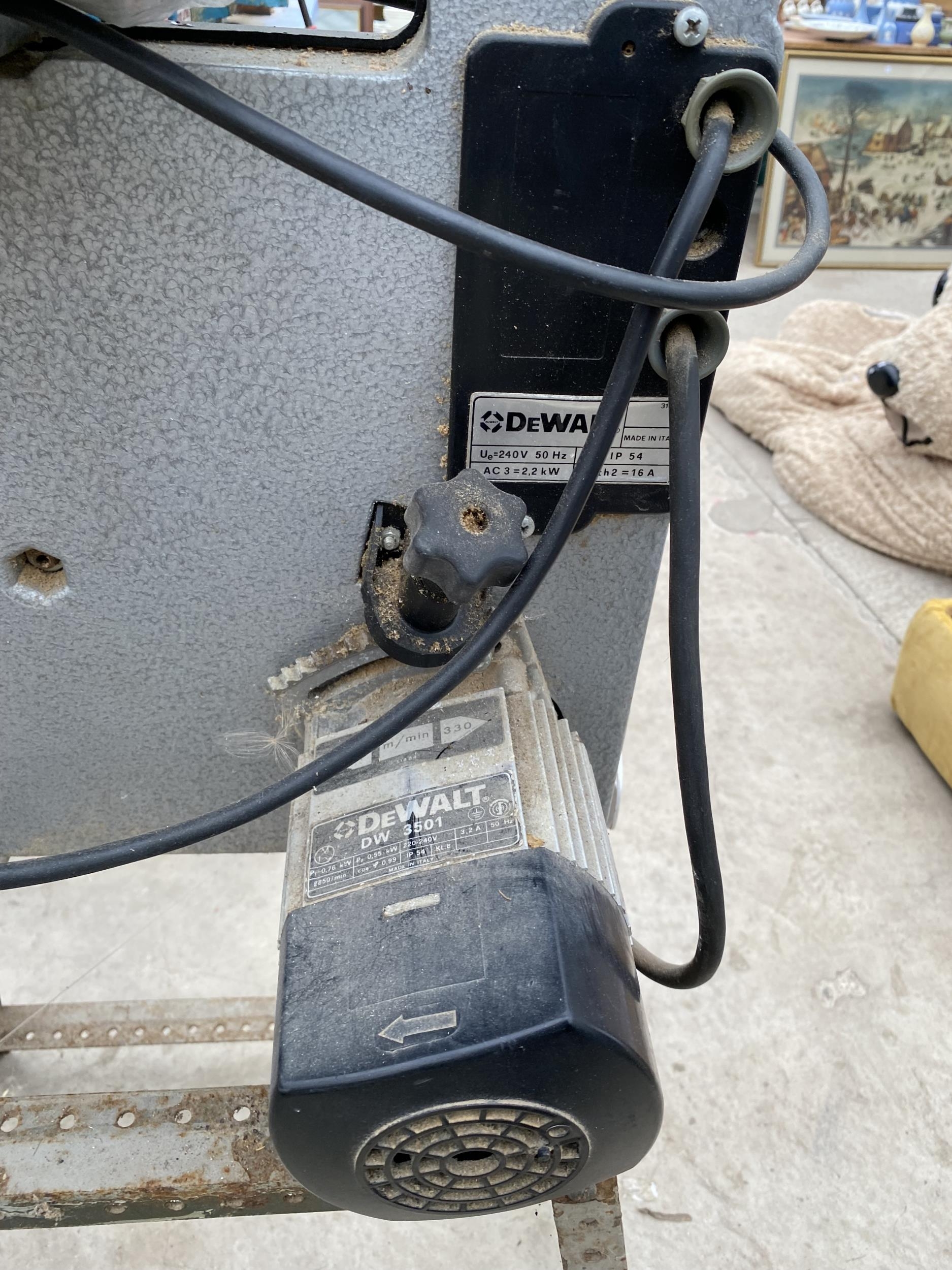 A DEWALT DW3501 ELECTRIC BAND SAW WITH STAND AND SPARE BLADES