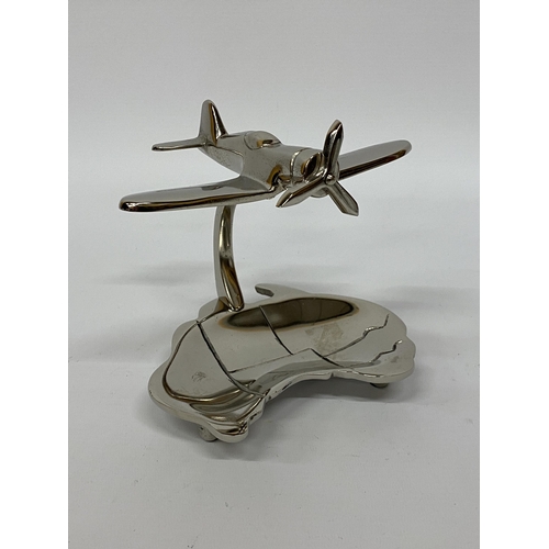 116 - A MODEL OF A CHROME SPITFIRE ON A DISH HEIGHT 15CM