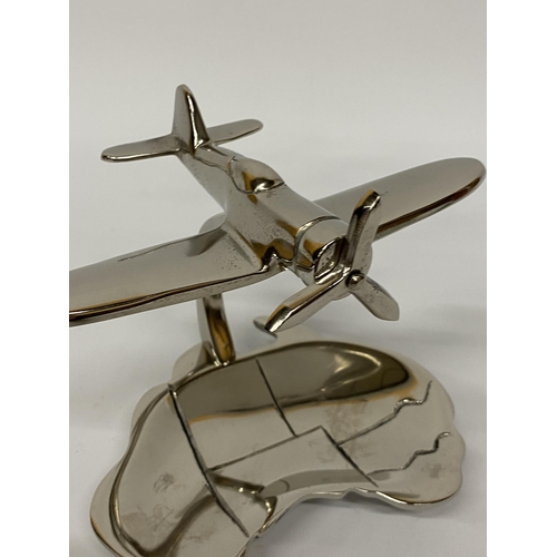 116 - A MODEL OF A CHROME SPITFIRE ON A DISH HEIGHT 15CM