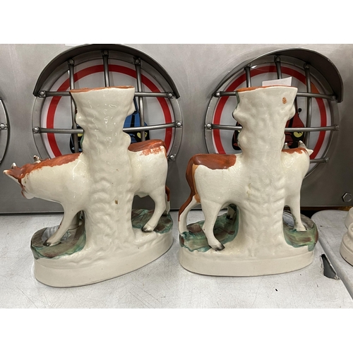 48 - A PAIR OF 19TH CENTURY STAFFORDSHIRE POTTERY COW SPILL VASES