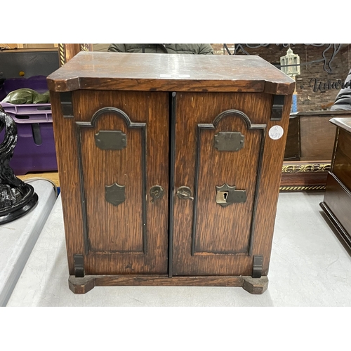 68 - AN EARLY 20TH CENTURY OAK TABLE TOP CABINET MODELLED AS A TWIN DOOR SAFE