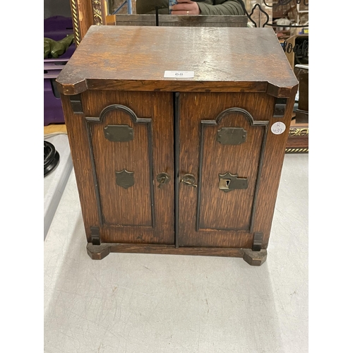 68 - AN EARLY 20TH CENTURY OAK TABLE TOP CABINET MODELLED AS A TWIN DOOR SAFE