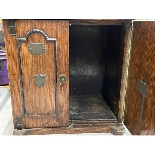 68 - AN EARLY 20TH CENTURY OAK TABLE TOP CABINET MODELLED AS A TWIN DOOR SAFE