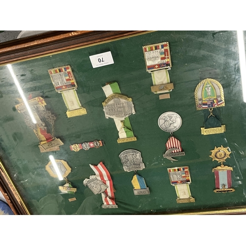 70 - A WOODEN AND GLASS DISPLAY CASE CONTAINING ASSORTED MILITARY MEDALS