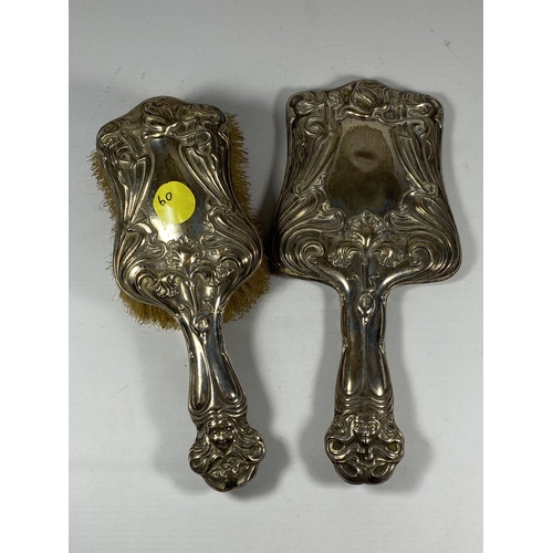 94 - AN EDWARDIAN SILVER BACKED ART NOUVEAU TWO PIECE DRESSING SET COMPRISING BRUSH AND MIRROR, HALLMARKS... 