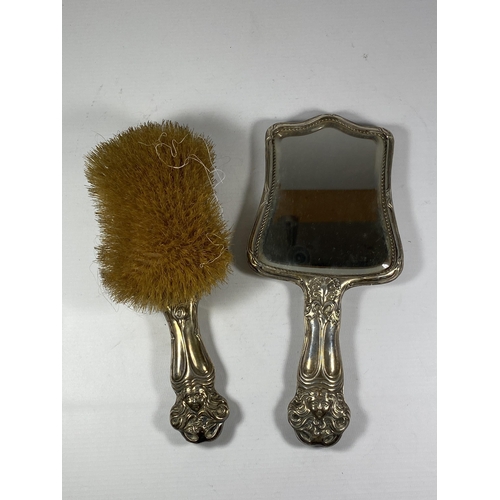 94 - AN EDWARDIAN SILVER BACKED ART NOUVEAU TWO PIECE DRESSING SET COMPRISING BRUSH AND MIRROR, HALLMARKS... 