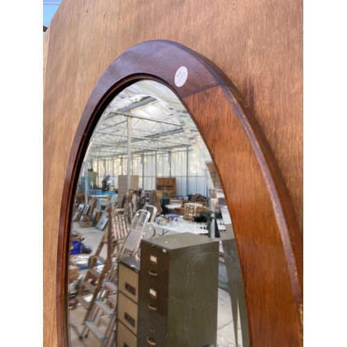 1207 - AN OVAL MAHOGANY FRAMED BEVELED EDGE WALL MIRROR