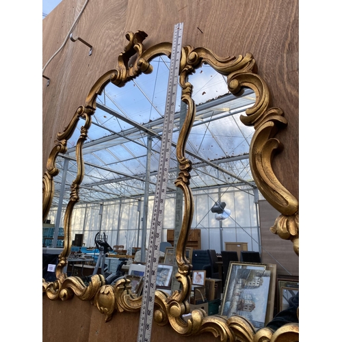 1222 - A LARGE DECORATIVE GILT FRAMED WALL MIRROR