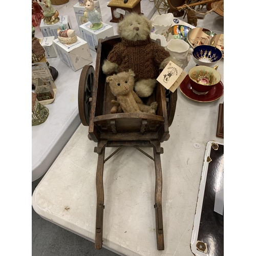 150 - A SMALL WOODEN CART WITH TWO TEDDY BEARS