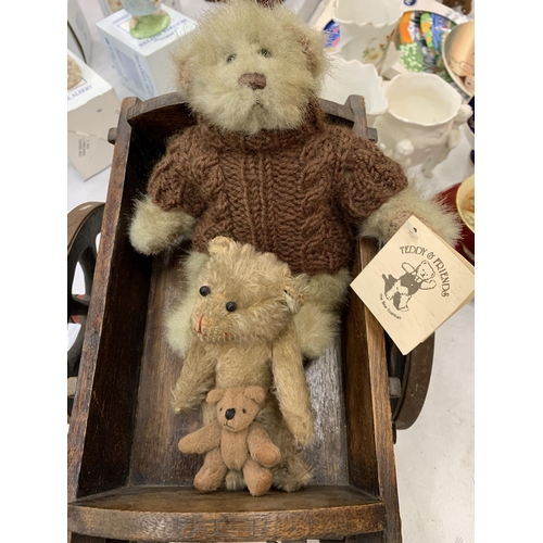 150 - A SMALL WOODEN CART WITH TWO TEDDY BEARS