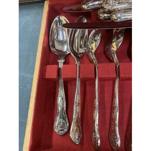 299 - A CANTEEN OF STAINLESS STEEL CUTLERY IN A TEAK BOX